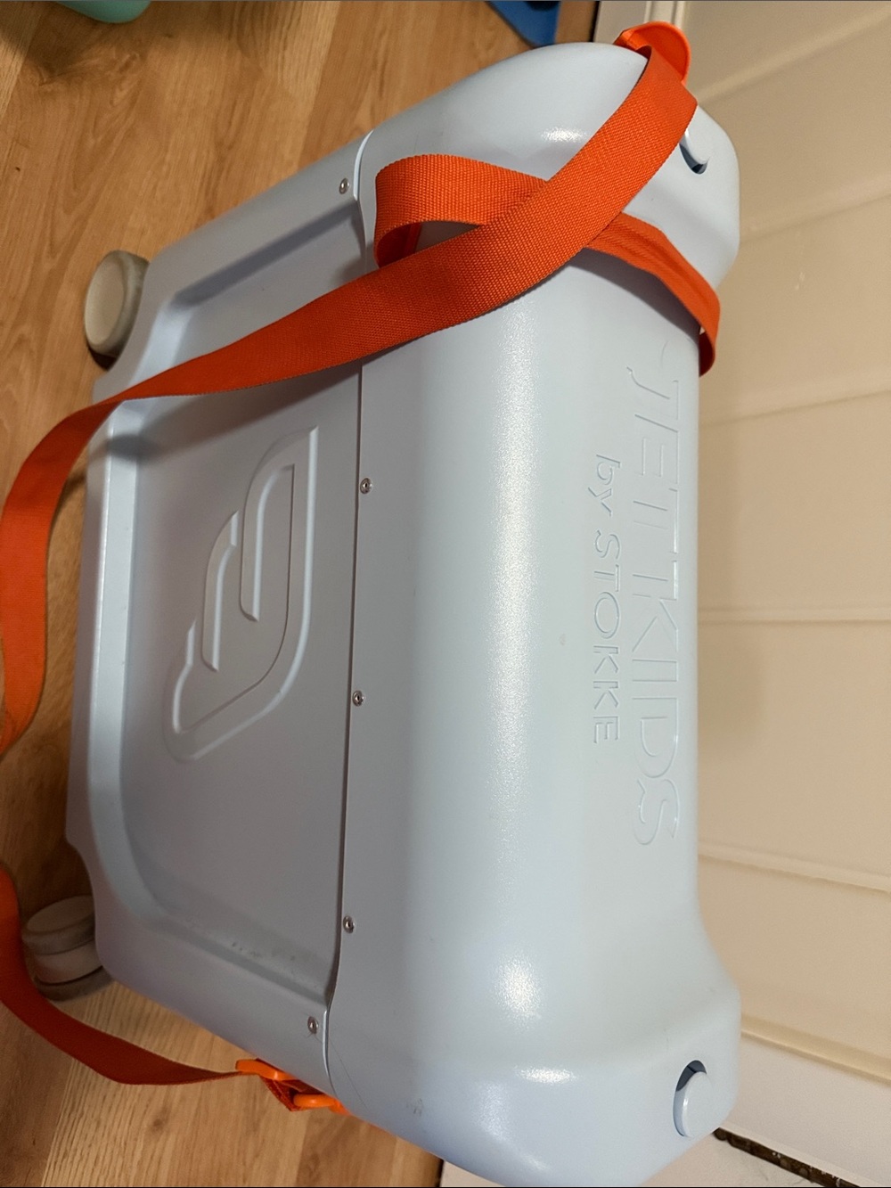 STOKKE  JetKids Ride-On Suitcase in Pale Blue with Orange Strap